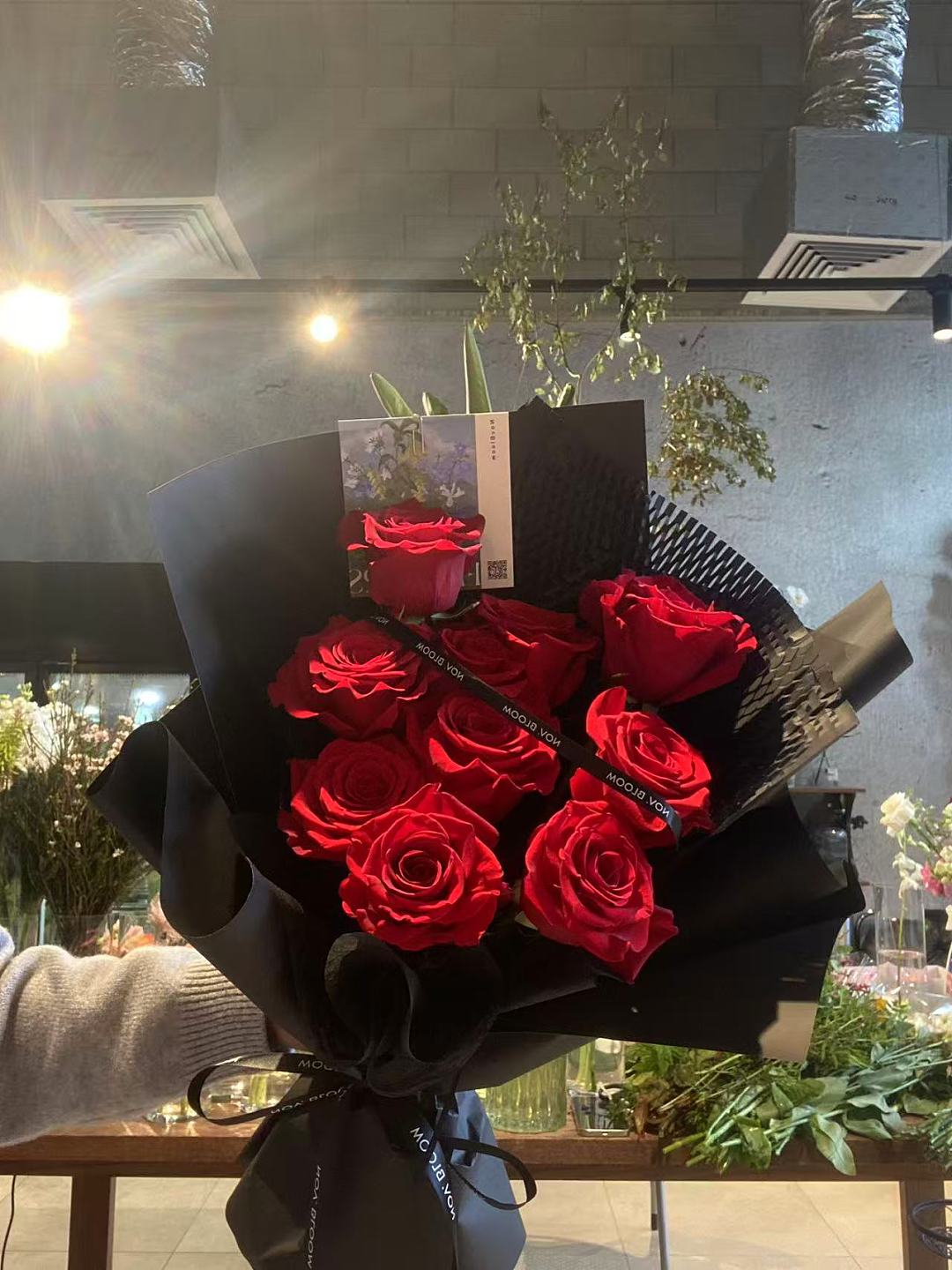 Red roses in black wrapping